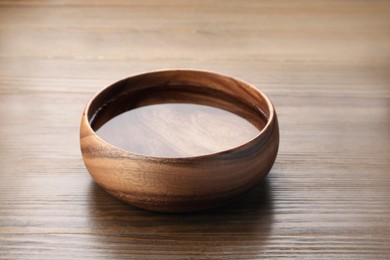 Photo of Bowl with pure water on wooden table