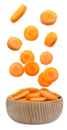 Image of Slices of fresh carrot falling into bowl on white background