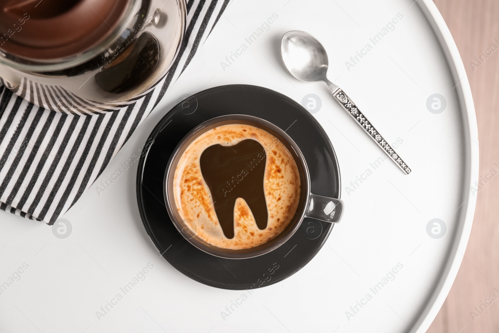 Image of Coffee causing dental problem. Cup of hot drink on table, top view