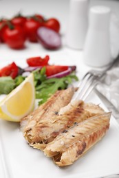 Photo of Delicious canned mackerel fillets served on table, closeup