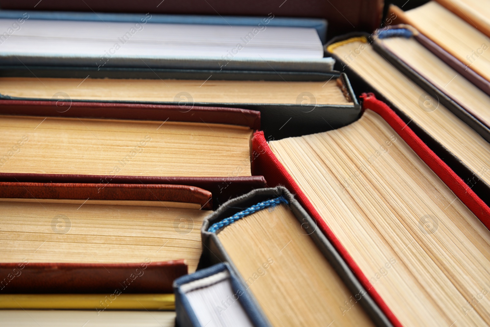 Photo of Many different hardcover books as background, closeup