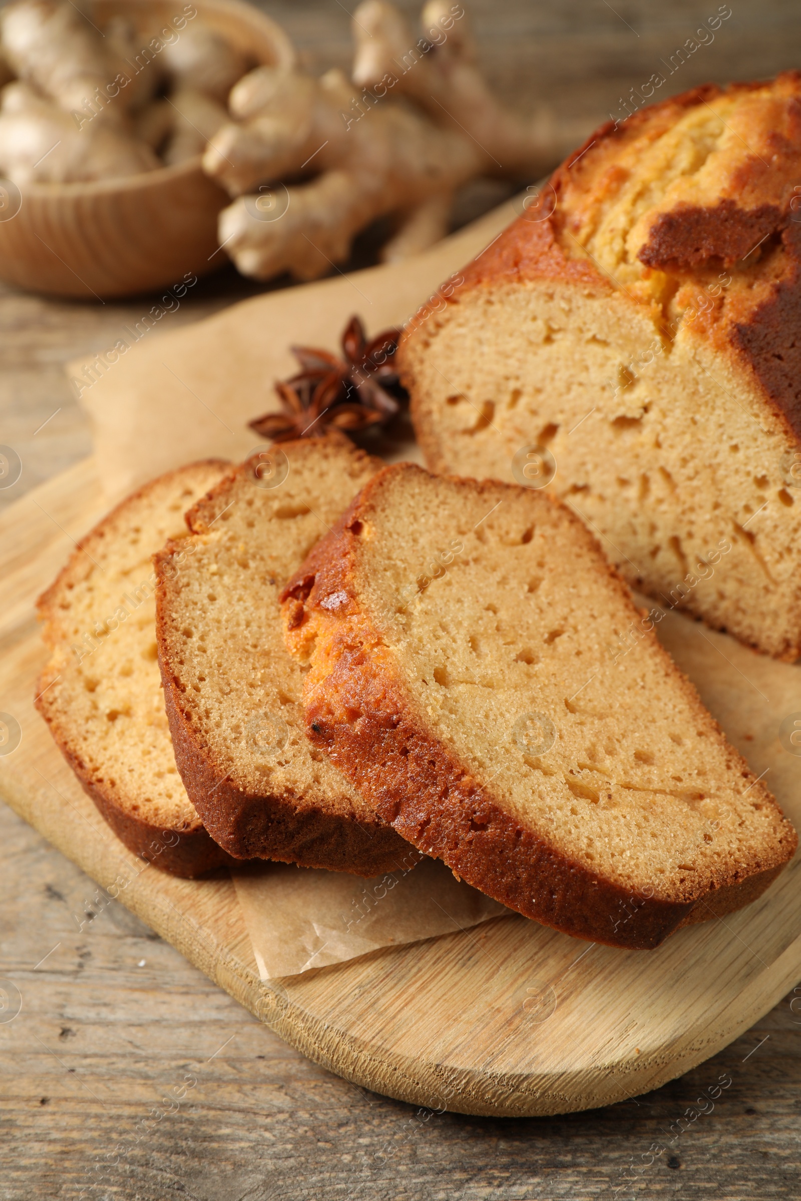 Photo of Sliced delicious gingerbread cake on wooden table, closeup