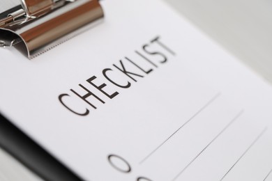 Photo of Closeup view of clipboard with inscription Checklist