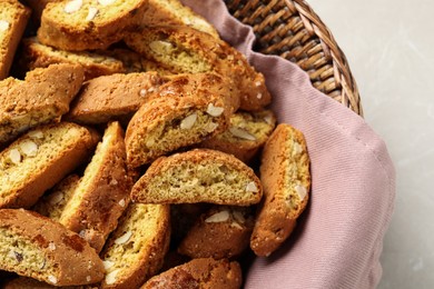 Traditional Italian almond biscuits (Cantucci) in basket on table, closeup