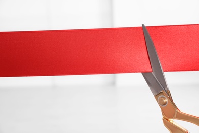 Photo of Ribbon and scissors on blurred background. Ceremonial red tape cutting