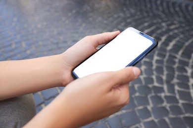 Photo of Young woman with smartphone outdoors, closeup view