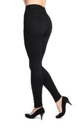 Photo of Woman wearing stylish black jeans and high heels shoes on white background, closeup
