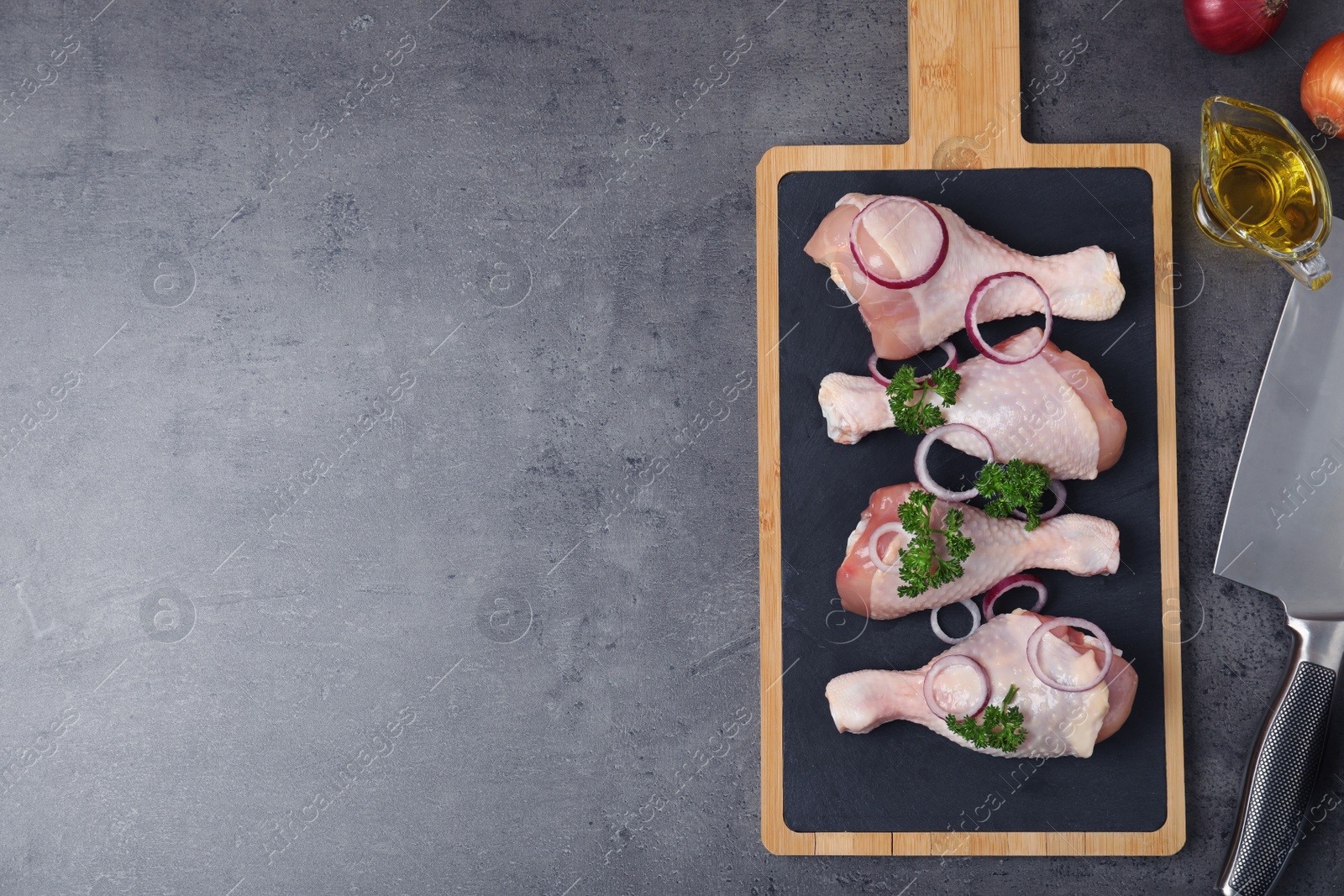 Photo of Flat lay composition with raw chicken meat and space for text on grey background