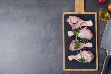 Photo of Flat lay composition with raw chicken meat and space for text on grey background