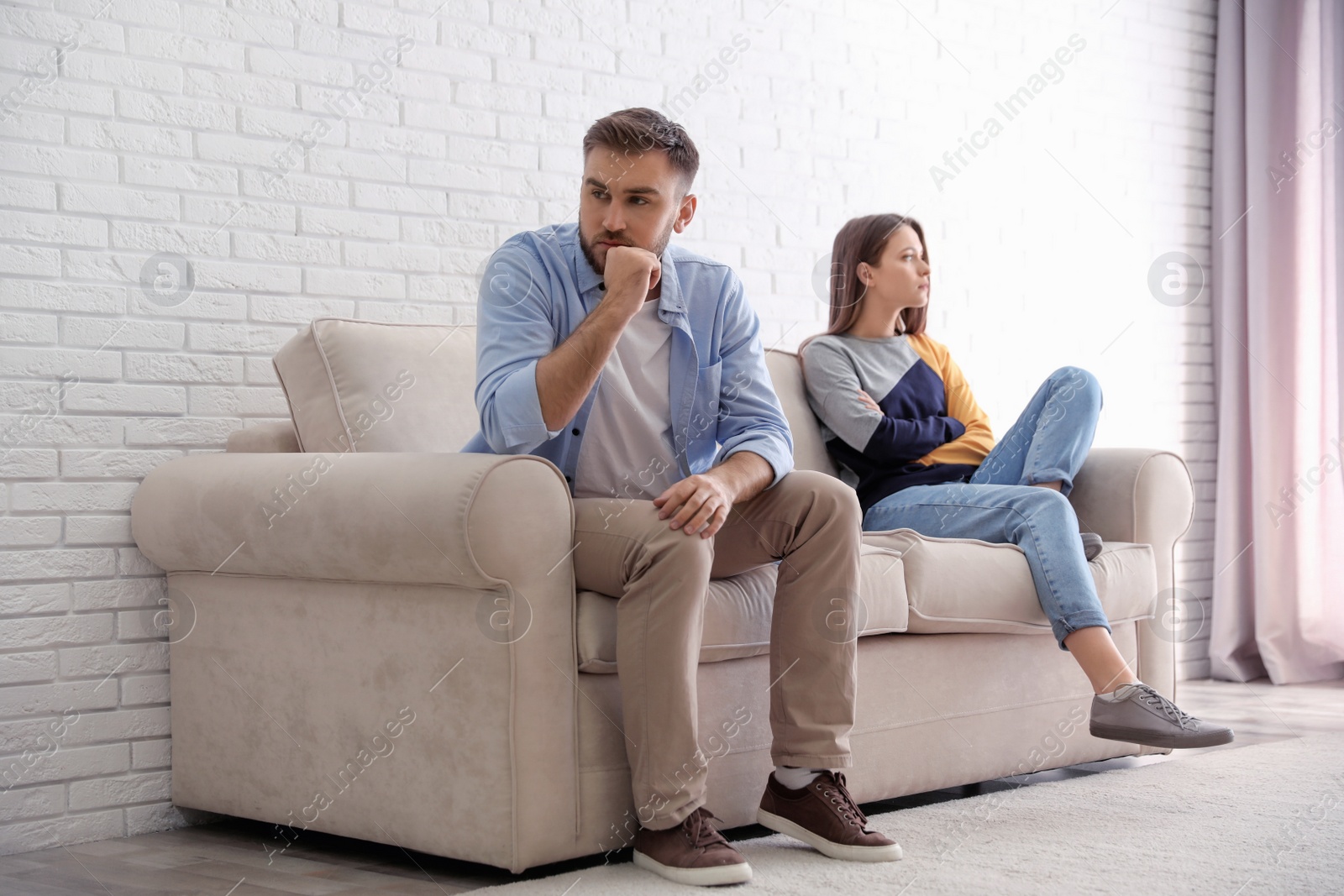 Photo of Unhappy couple with problems in relationship at home