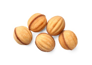 Photo of Delicious nut shaped cookies with condensed milk on white background, top view