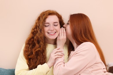 Beautiful young sisters spending time together at home