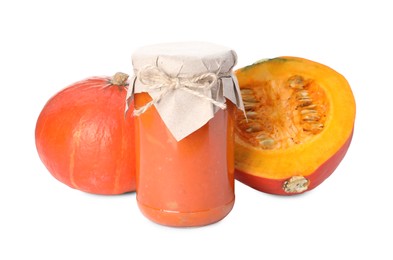 Jar of pumpkin jam and fresh pumpkins on white background