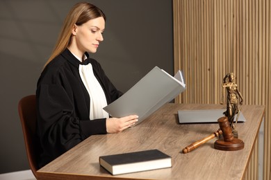 Judge with folder working at table in courtroom