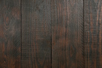 Photo of Texture of dark brown wooden surface as background, closeup