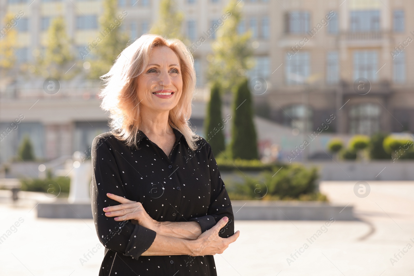 Photo of Portrait of happy mature woman on city street