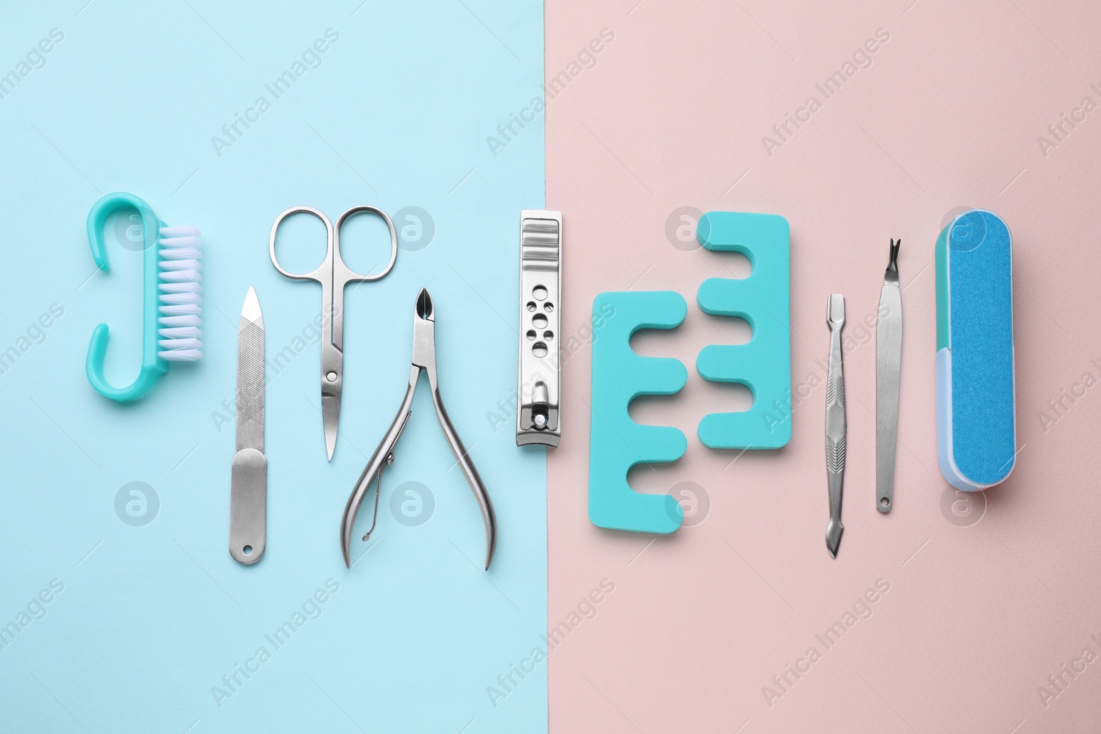 Photo of Set of pedicure tools on color background, flat lay