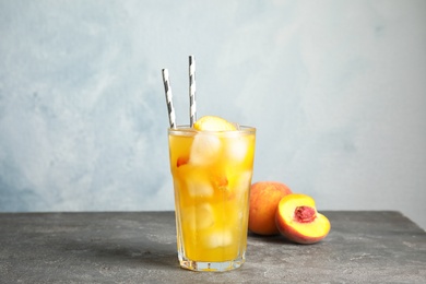 Tasty peach cocktail on table. Refreshing drink