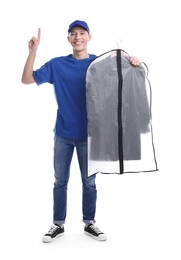 Dry-cleaning delivery. Happy courier holding garment cover with clothes and pointing at something on white background