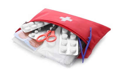 Photo of Red first aid kit with scissors, pills, plastic forceps and medical plasters isolated on white
