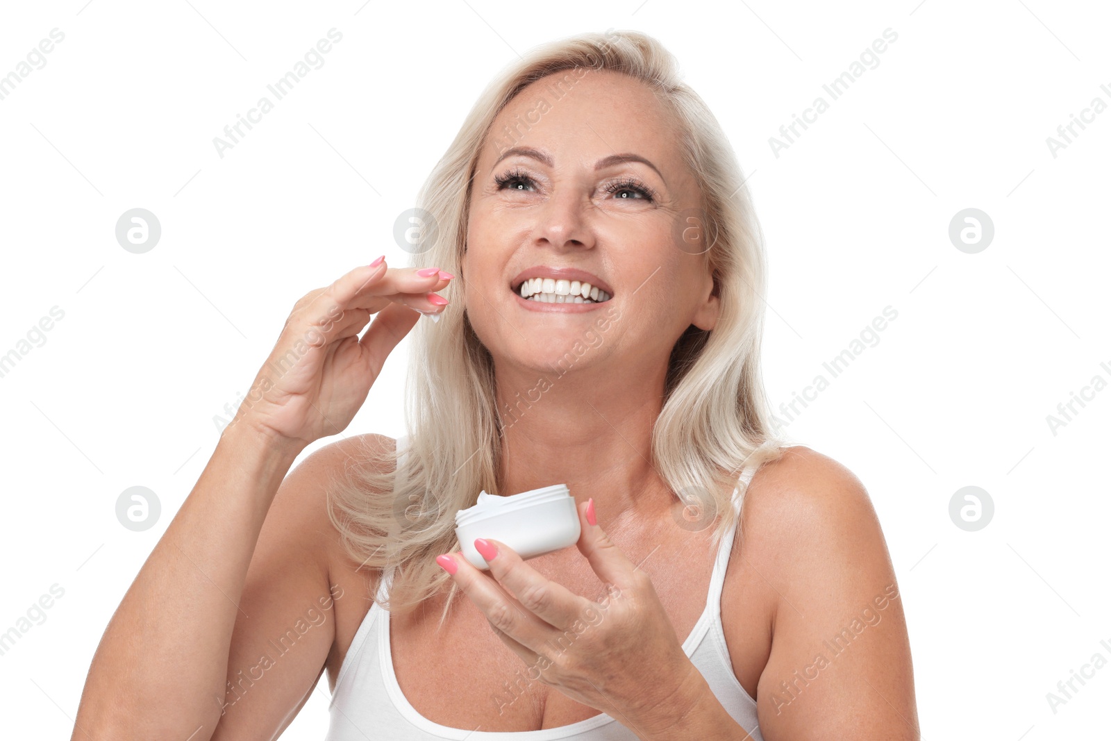 Photo of Portrait of beautiful mature woman with perfect skin holding jar of cream on white background