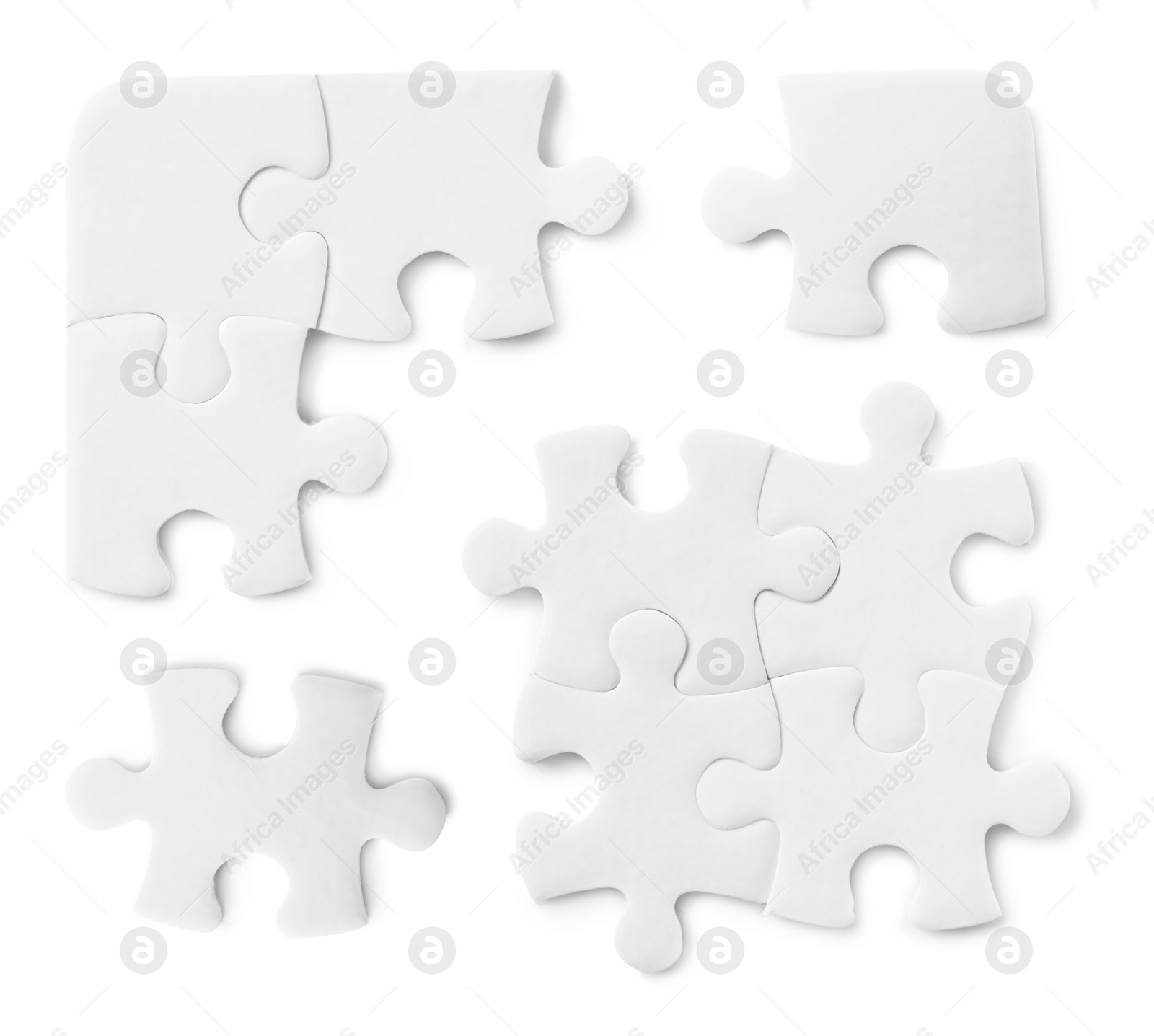 Image of Set with jigsaw puzzle pieces on white background, top view