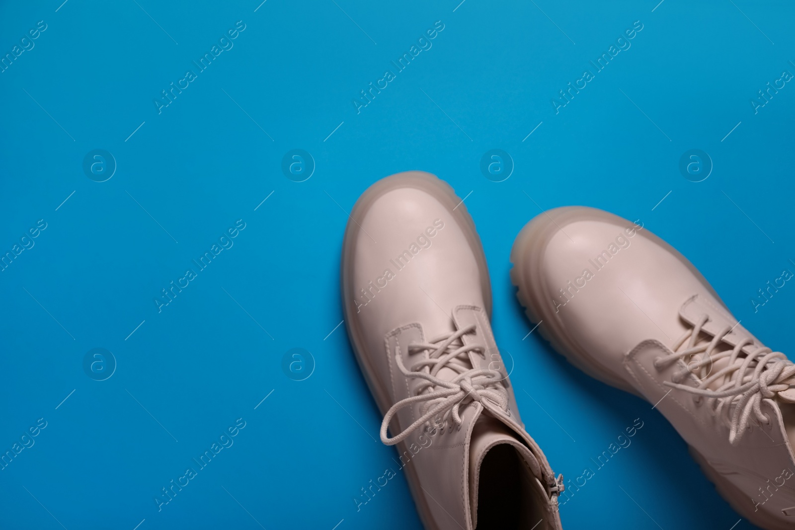 Photo of Pair of stylish leather shoes on light blue background, flat lay. Space for text