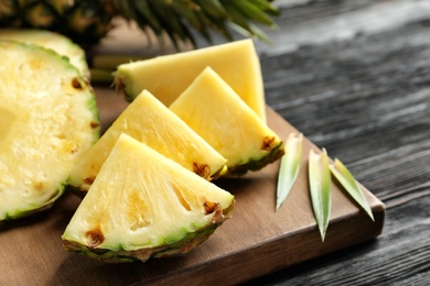 Fresh sliced pineapple on wooden board, closeup