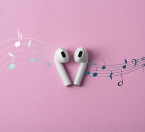 Modern wireless earphones on pink background, top view 
