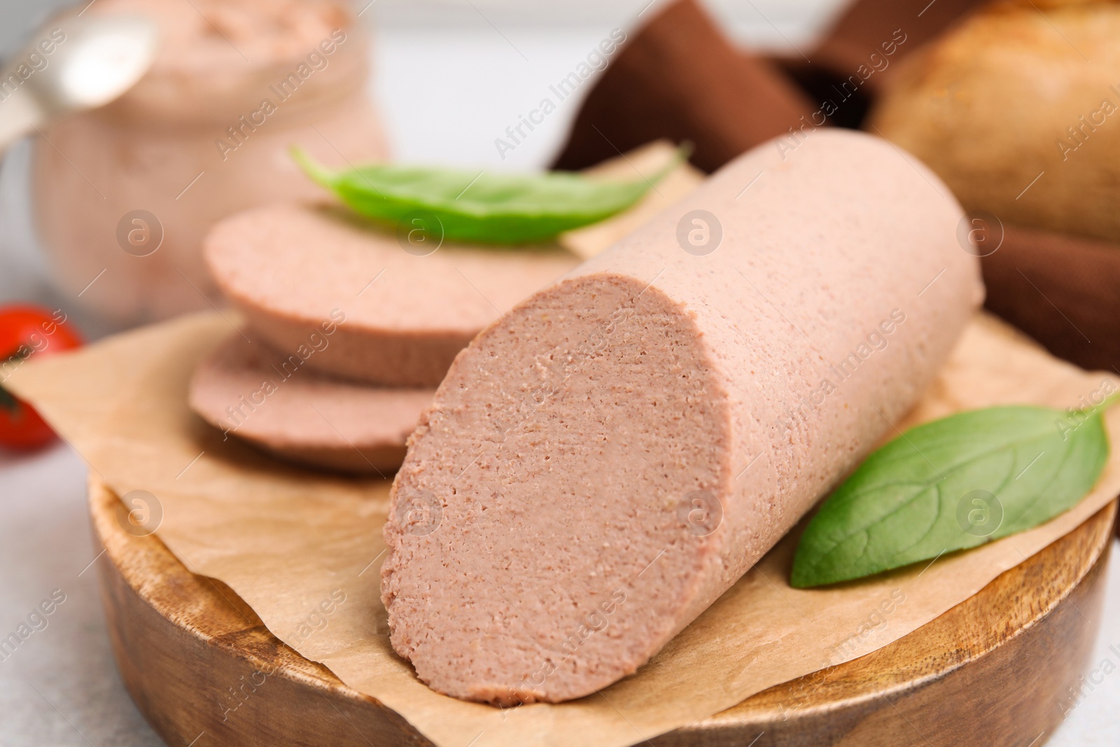 Photo of Delicious liver sausage on light grey table, closeup