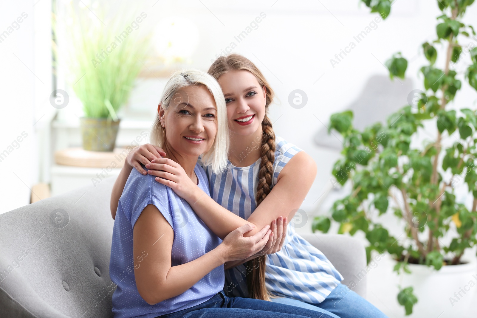 Photo of Mother and her adult daughter spending time together at home