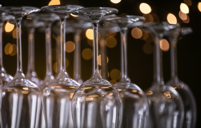 Photo of Empty glasses against blurred lights, closeup view