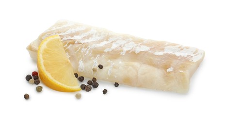 Fresh raw cod fillet with peppercorns and lemon isolated on white