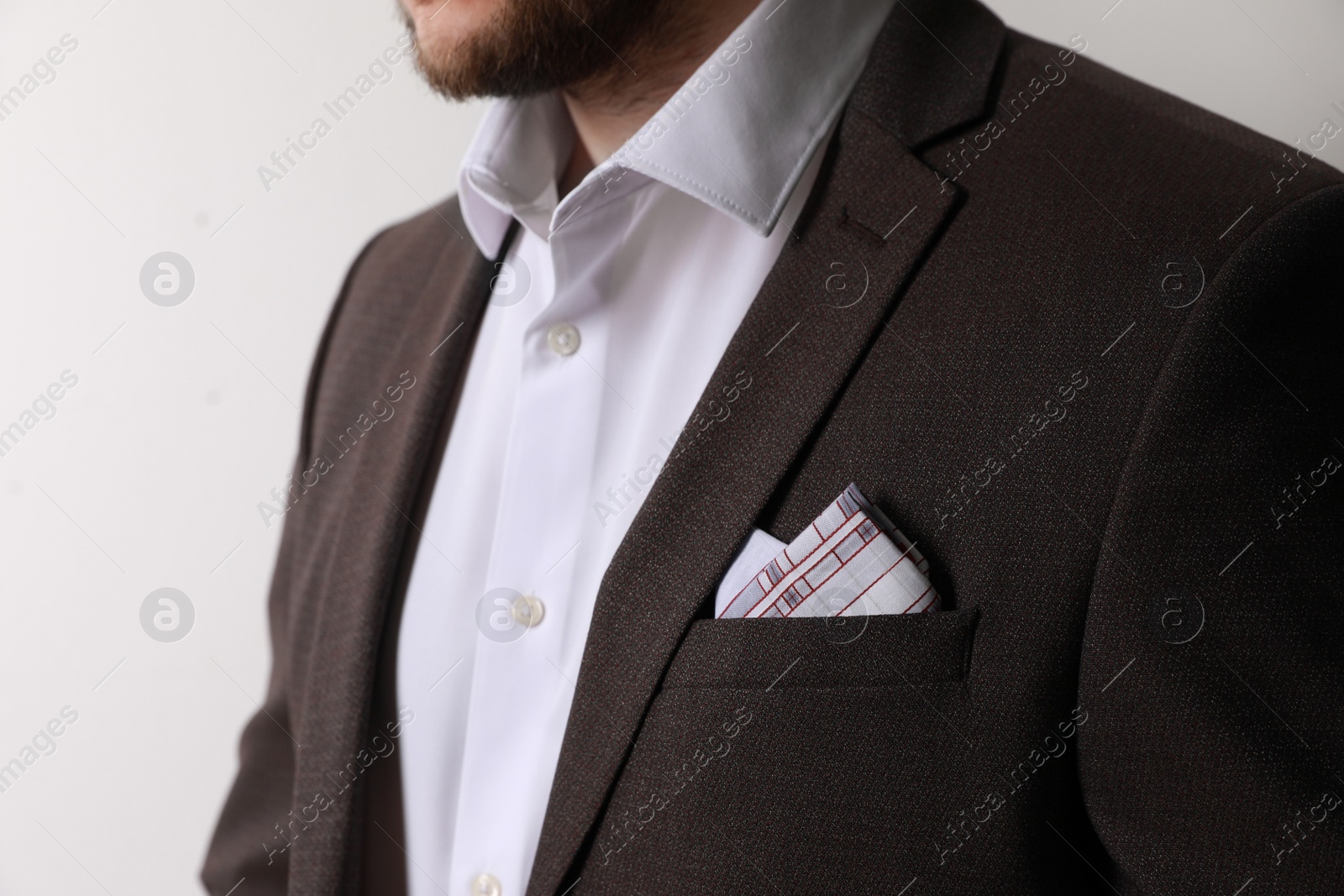 Photo of Man with handkerchief in suit pocket on white background, closeup