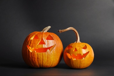 Photo of Halloween pumpkin head jack lanterns on dark background