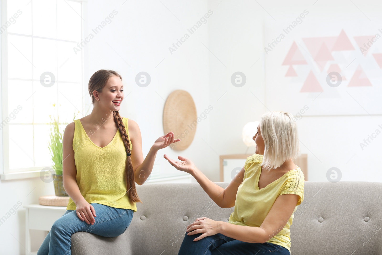 Photo of Mother and her adult daughter spending time together at home