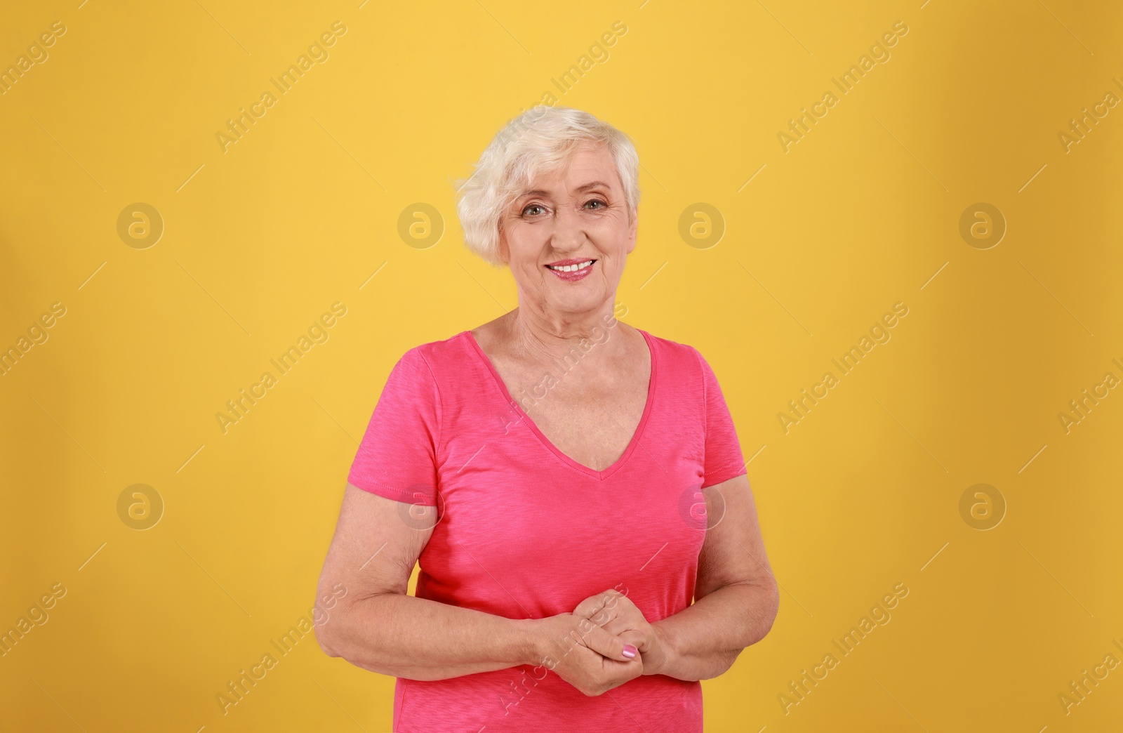 Photo of Senior woman in casual outfit on yellow background