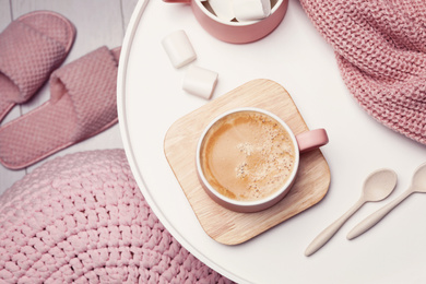 Photo of Cup of hot coffee and marshmallows on white table, top view. Winter drink