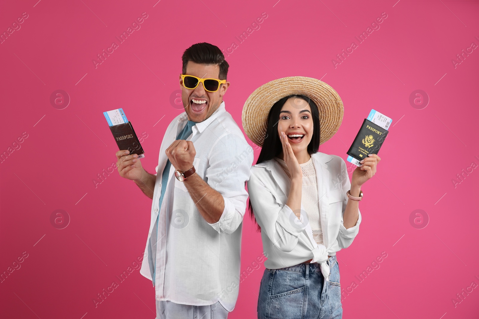 Photo of Couple of tourists with tickets and passports on pink background