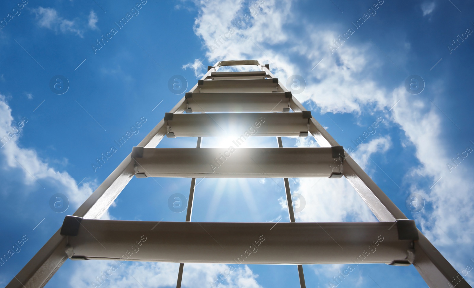 Image of Metal stepladder against blue sky with clouds, low angle view