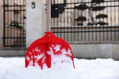 Snow shovel with wooden handle outdoors. Space for text