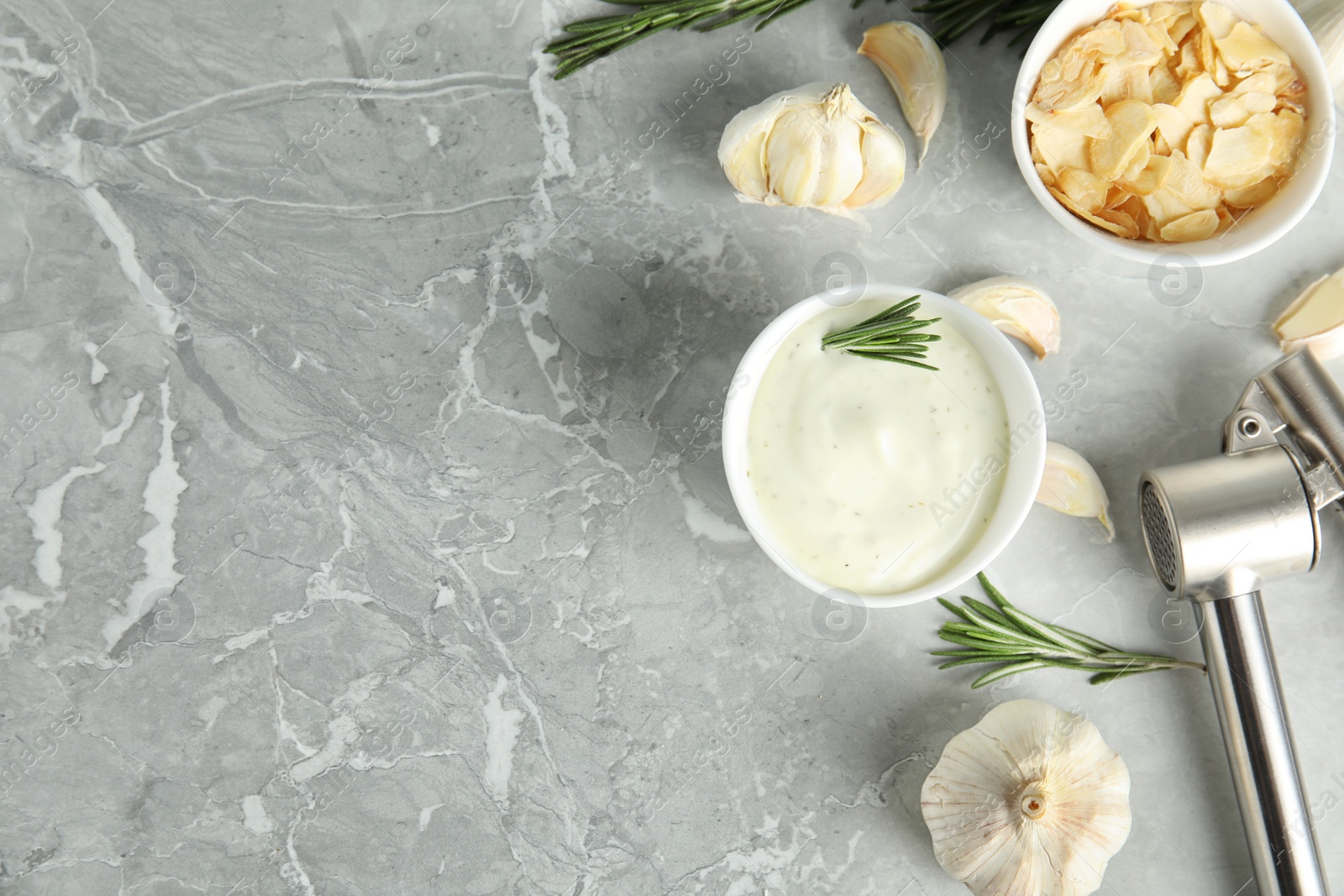 Photo of Flat lay composition with garlic sauce and flakes on grey background. Space for text