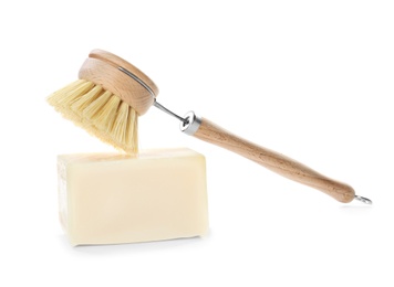 Photo of Cleaning brush and soap bar for dish washing on white background
