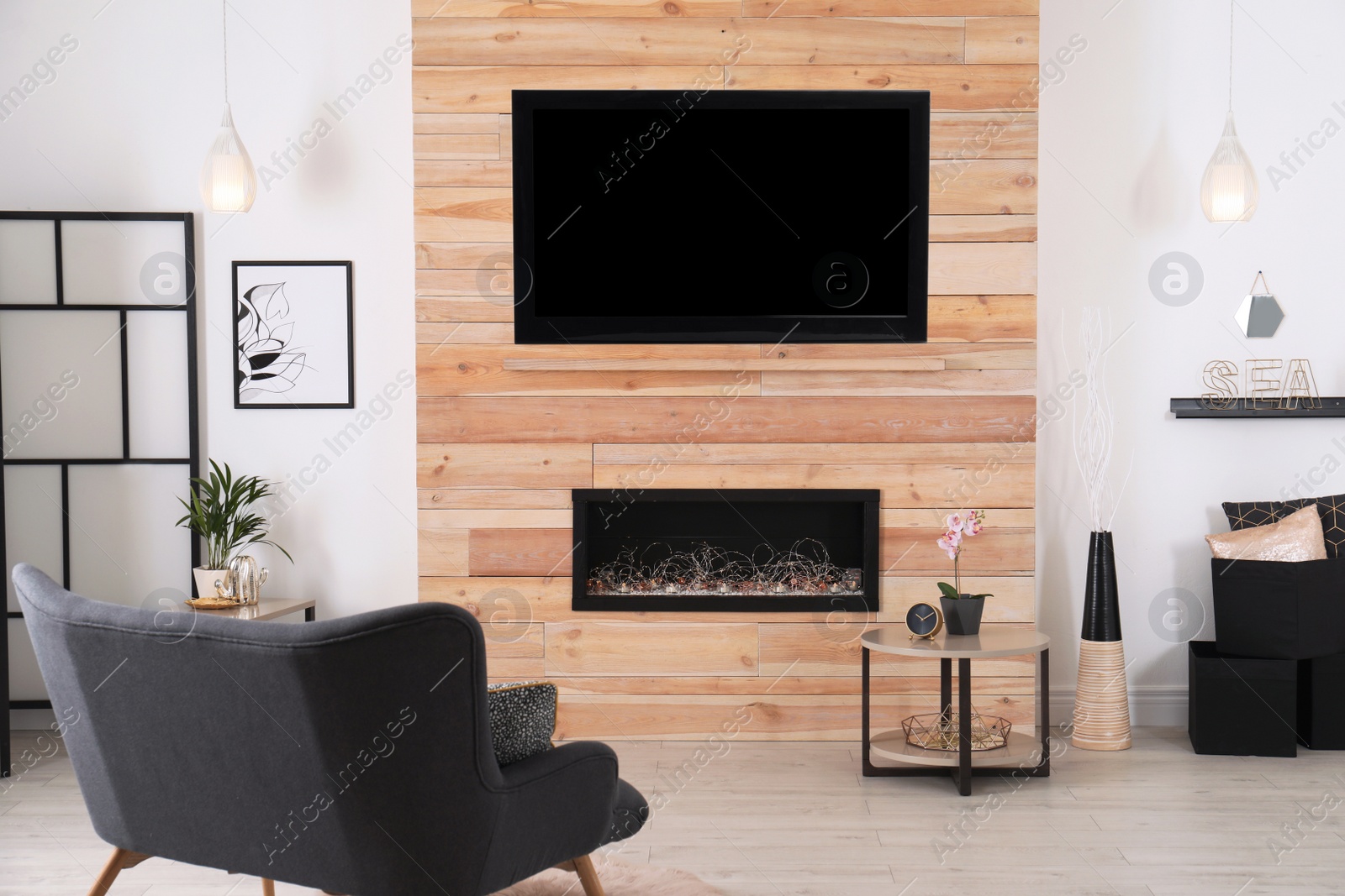 Photo of Living room interior with decorative fireplace in wooden wall