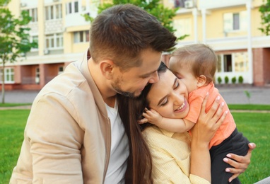 Happy family with adorable little baby outdoors