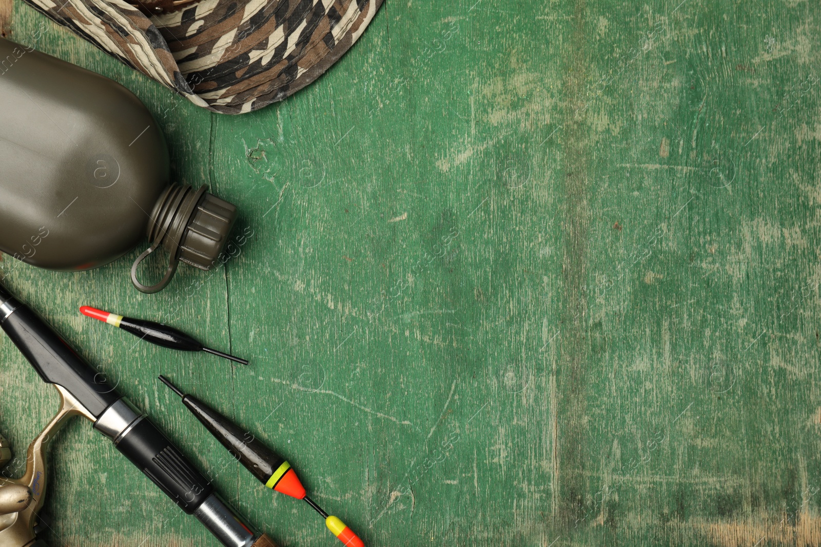 Photo of Flat lay composition with fishing equipment and space for text on wooden background