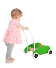 Photo of Cute baby playing with toy walker on white background