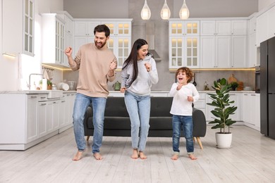 Happy family dancing and having fun at home