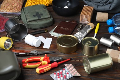 Photo of Disaster supply kit for earthquake on wooden table