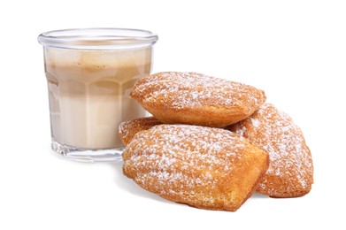 Photo of Delicious madeleine cakes with powdered sugar and glass of latte on white background